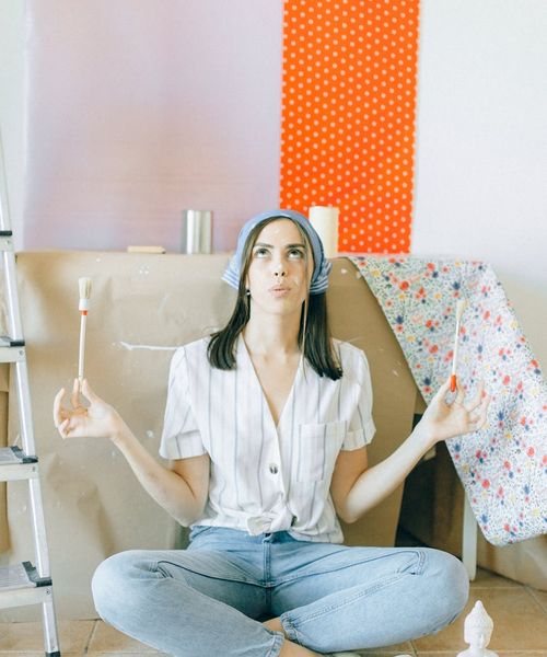 A person sitting in a meditative yoga pose against a clean white background.